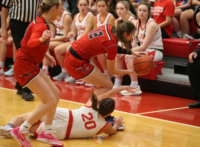 Yorkville's Lainey Gussman regains control of the ball as Ottawa's Kendall Lowery lunges toward it on Monday, Dec. 4, 2023 at Kingman Gym.