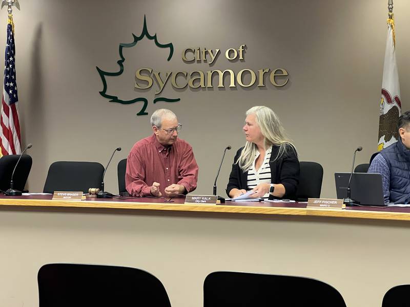 First Ward Sycamore Alderperson Alan Bauer and Sycamore Clerk Mary Kalk on Nov. 4, 2024, talk before a City Council meeting begins. They're running for reelection to their respective offices in the April 2025 consolidated election.