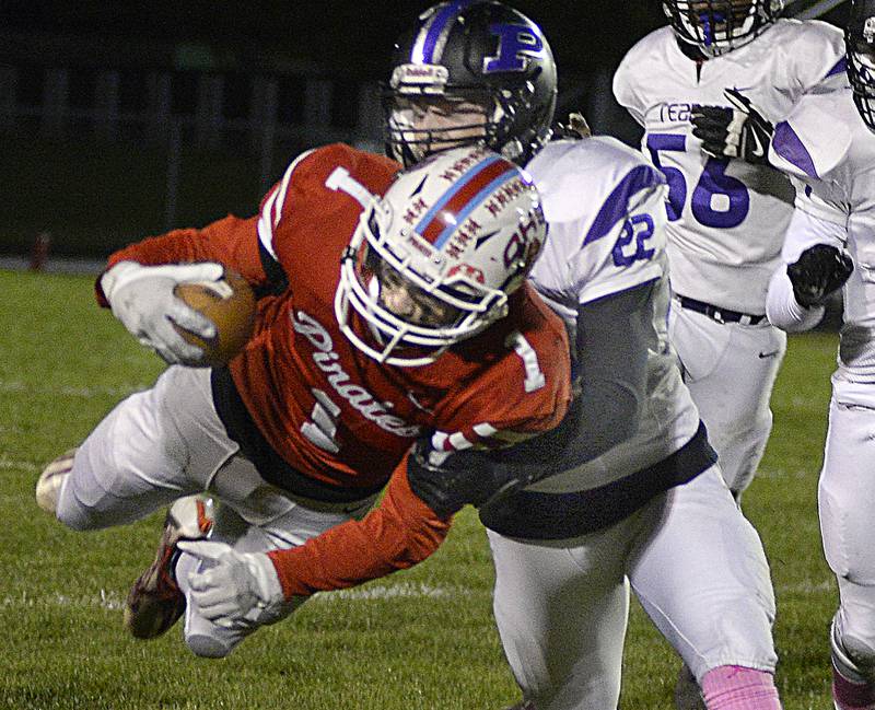 Plano’s Sean Earwood (22) brings down leaping Ottawa ballcarrier Levi Sheehan (1) on a first-down attempt Friday, OCt. 22, 2021, at Ottawa's King Field.