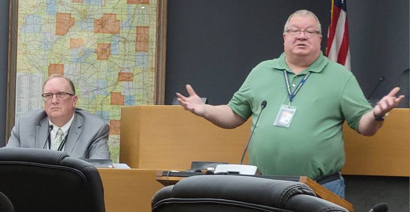 La Salle County EMA director Fred Moore (right) explains to the La Salle County Board's Rules and Legislation Committee his agency's plan for an unscheduled bus drop-off of illegal immigrants.