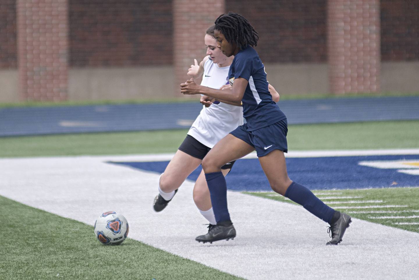 Dixon's Emily Smith and Sterling's Taah Liberty race after a ball Tuesday, May 10, 2022.