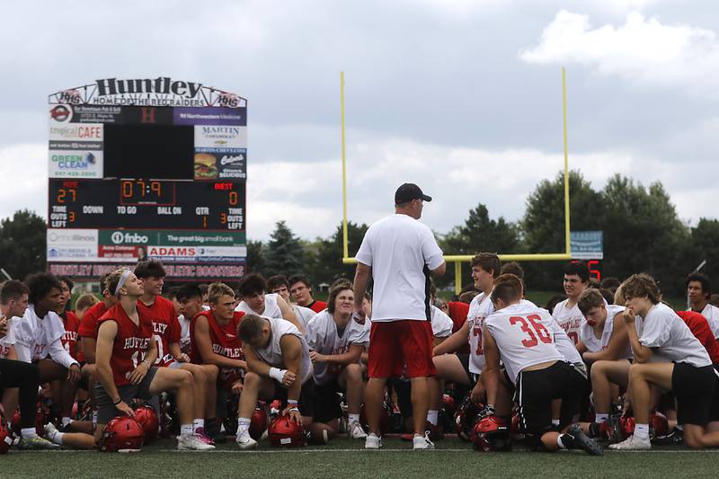 Huntley football Mike Naymola speaks to the team during the first day of football practice Monday, August 7, 2023, at the Huntley High School’s Red Raider Stadium.