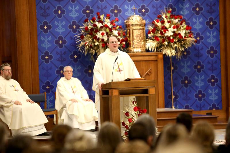 Reverend Jared Twenty, pastor of Holy Cross Catholic Church in Batavia, gives the homily for Reverend Jonathan Bakkelund during the Mass of Christian Burial at St. Peter Catholic Church in Geneva on Wednesday, Jan. 31, 2024.
