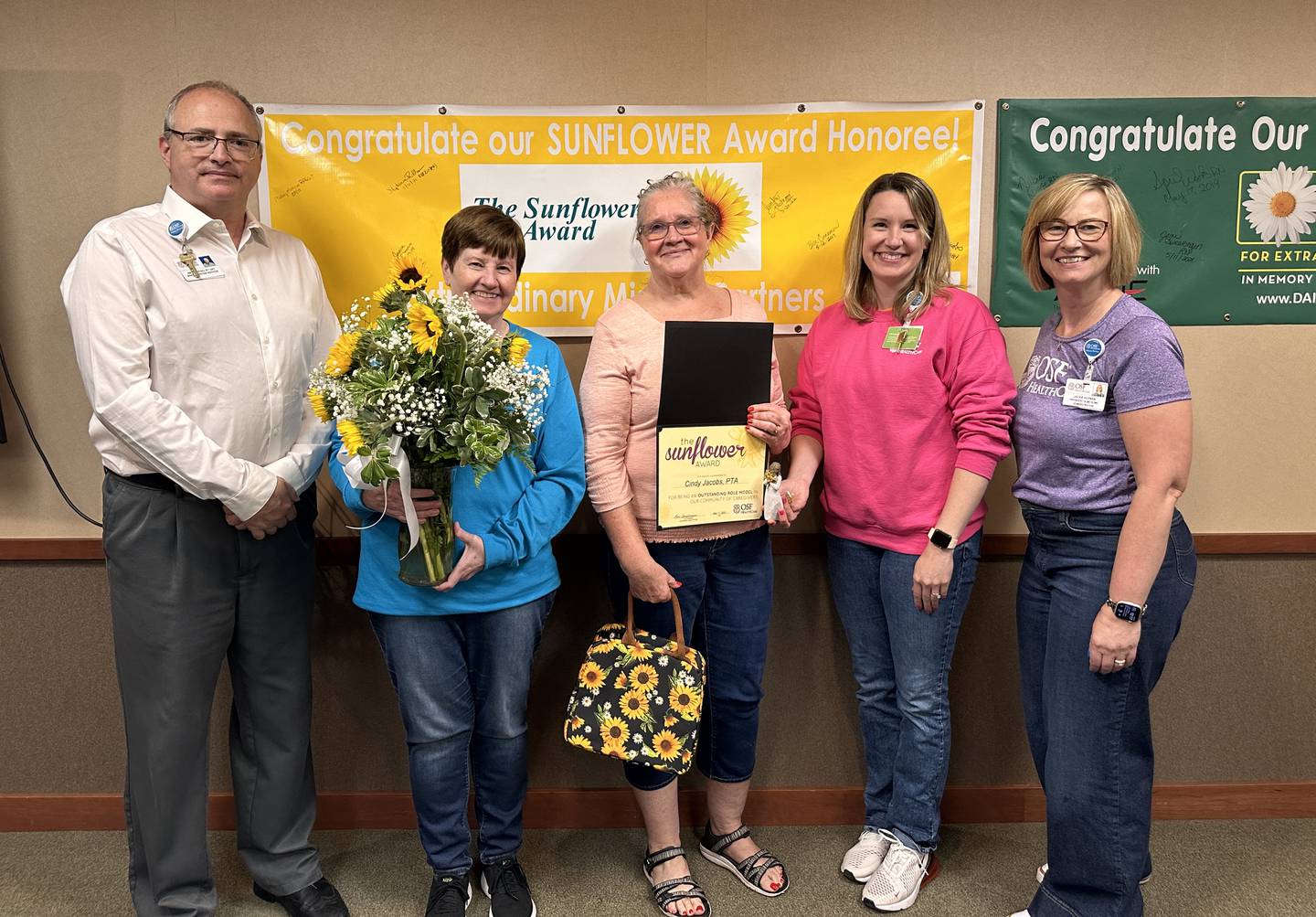 Cindy Jacobs, physical therapy assistant and 2024 Sunflower Award winner is pictured with OSF Saint Luke leaders.