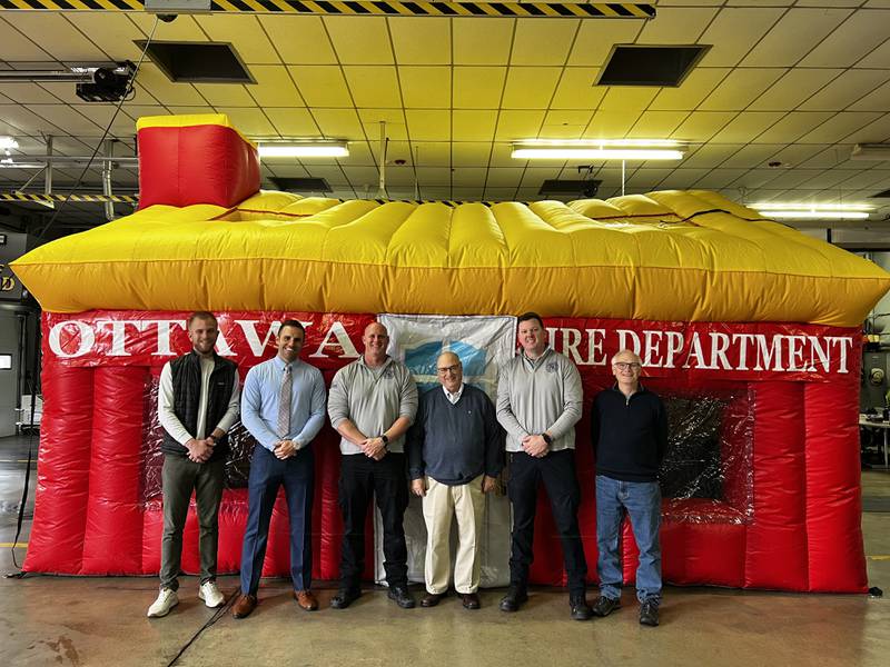 Gentry Nordstrom; Noon Rotary president Blake Baker; Capt. Kevin Theis; retired Chief Rick Scott; Chief Brian Bressner and Sunrise Rotary President Gene Anderson pose in front of the new fire house.