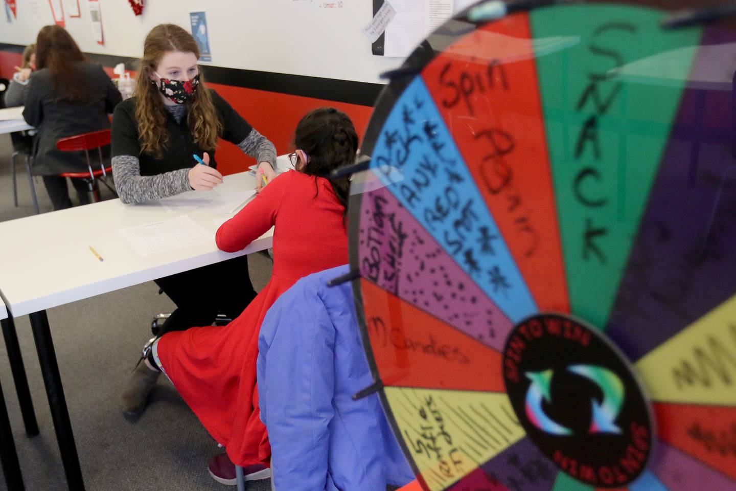 Mathnasium tutor Grace Clark, a senior at Jacobs High School, helps fourth grade student Sarah Cartwright with math problems at Mathnasium on Thursday, Feb. 11, 2021 in Algonquin.