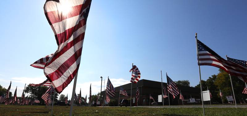 American flags, put up by True Patriots Care, surround McHenry Township Fire Protection District Station 2 on Johnsburg Road in Johnsburg on Thursday, Sept. 11, 2025. The Flags of Honor is on  display at Station 2 through September 15. This exhibit honors the 343 brave firefighters who lost their lives during the tragic events of September 11, 2001, with each flag symbolizing their courage and sacrifice.