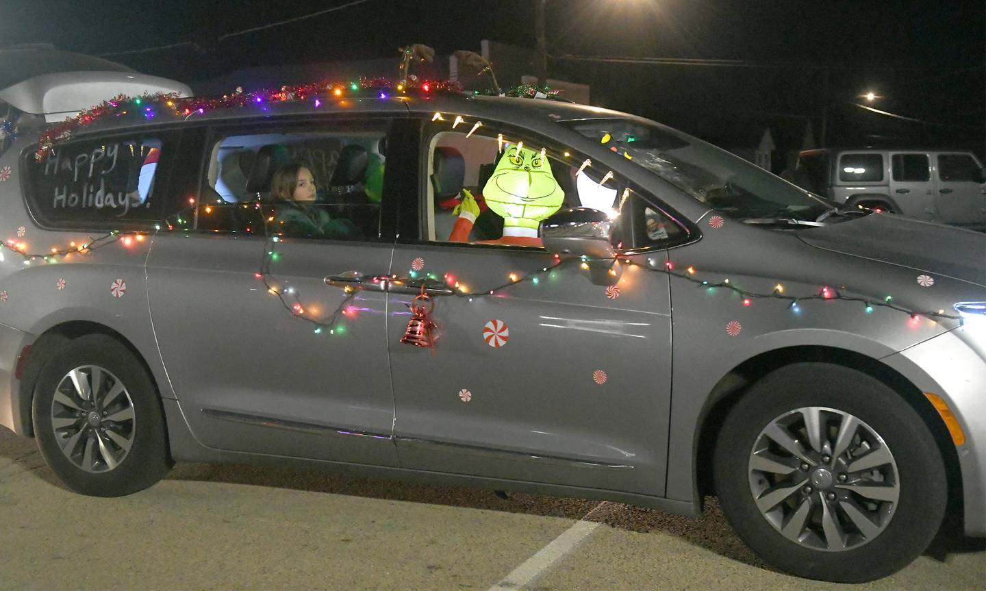 The Grinch rides in one of the vehicles that took part in the lighted parade during Mt. Morris' Festival of Lights  on Dec.3.