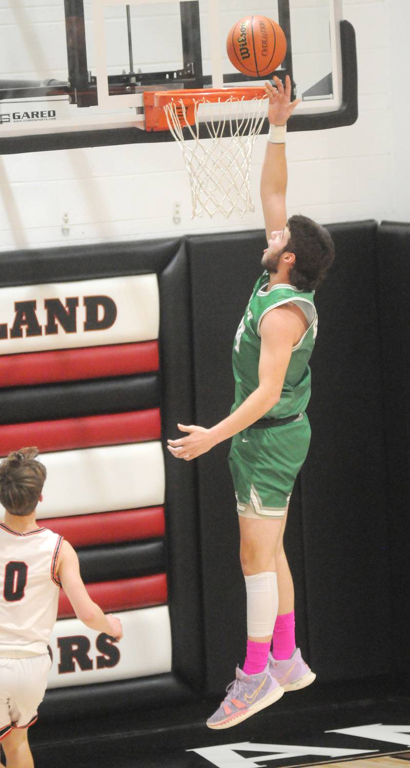 Dwight's Wyatt Thompson scores on a fast break as Woodland's Carter Ewing trails at the Warrior Dome on Friday, jan. 13, 2023.