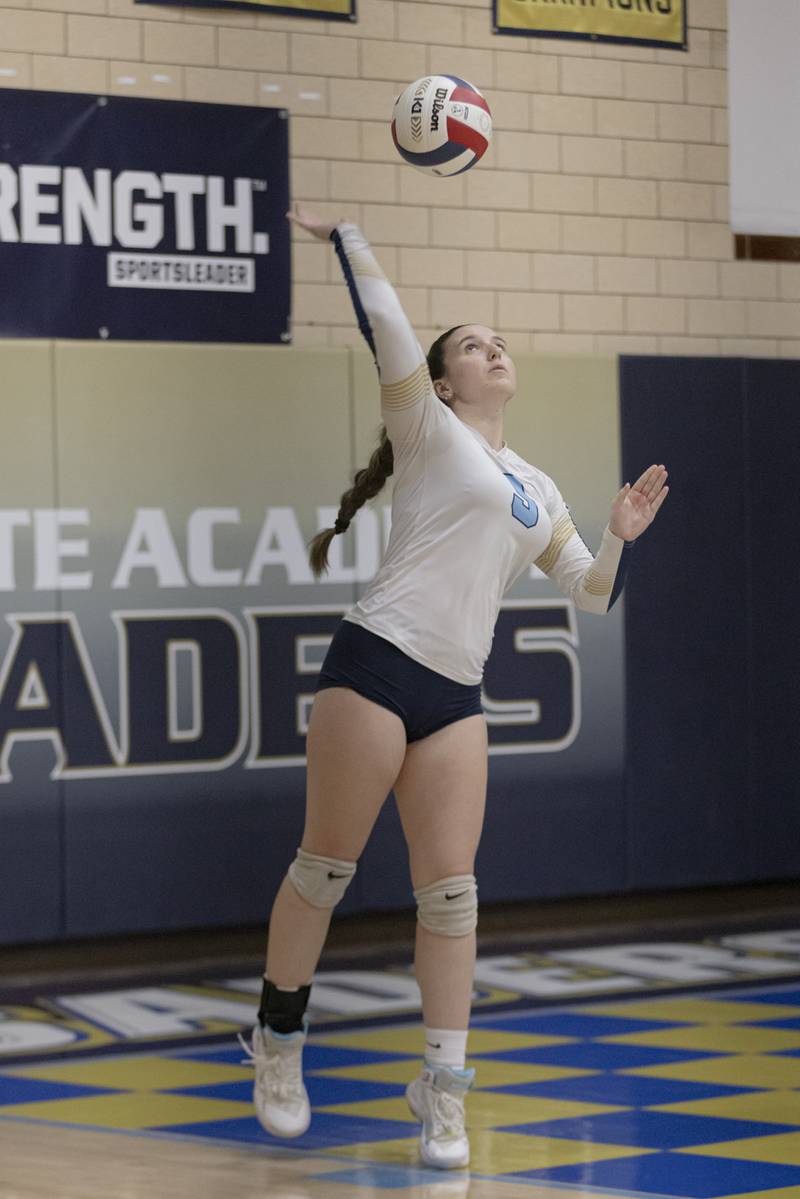 Hailey Abbott of Marquette serves the ball against Lexington High School during the Class 1A Sectional girls volleyball tournament at Bader Gym on November 5, 2024.