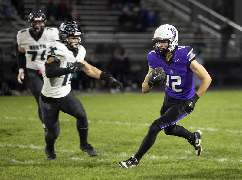 Dixon’s Jackson Koehler looks for running room against Woodstock North Friday, Oct. 31, 2025, in the Class 4A football first round playoffs.