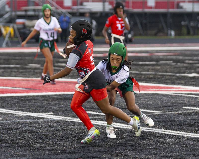 Bolingbrook's Jonas Richardson (5) takes off with the ball during flag football game between Plainfield Central at Bolingbrook Wednesday, Sept 3, 2025  in Bolingbrook.