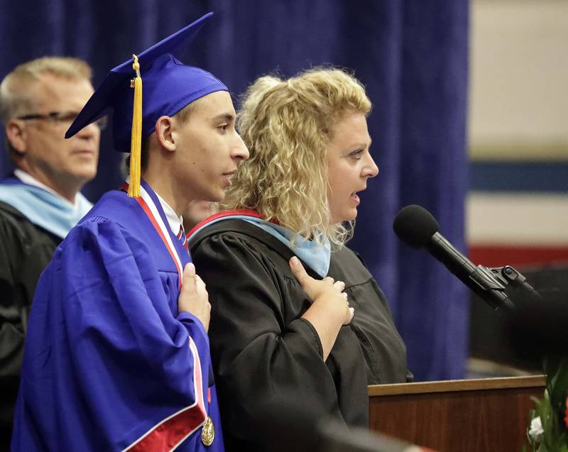 Ms. Jessica Santee and Eagle Scout Ryan Dodd lead the Pledge of Allegiance during the Glenbard South High School graduation ceremony Friday May 20, 2022 in Glen Ellyn.