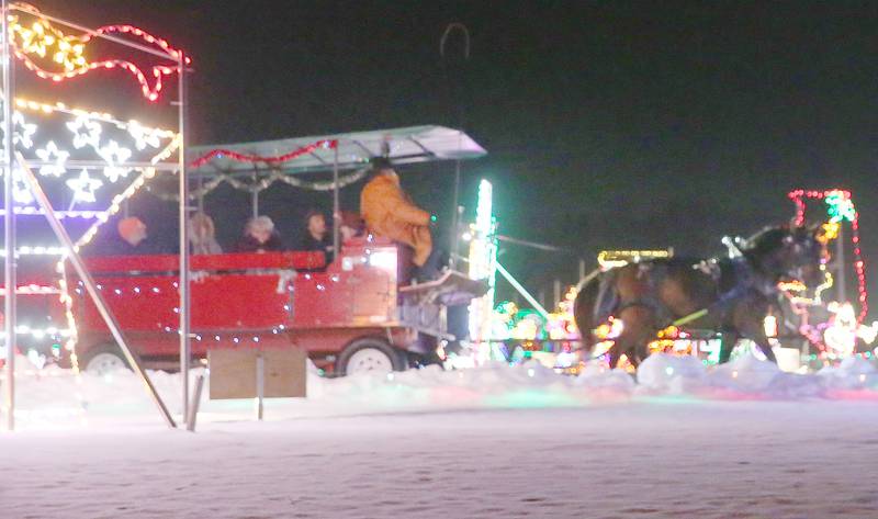 Tony Troyer of Arabian Carriage Co. leads a team of horses through the Christmas lights on Tuesday, Rotary Park on Tuesday, Dec. 9, 2025 in La Salle. Carriage rides are offered in November and December at Rotary Park. The last ride is scheduled for Thursday, Dec. 11. Prices are $25 per person or $200 for the entire wagon up to a dozen people. The carriage rides are organized by the Illinois Valley Chamber of Commerce. For more information visit https://www.ivaced.org/carriage-rides.