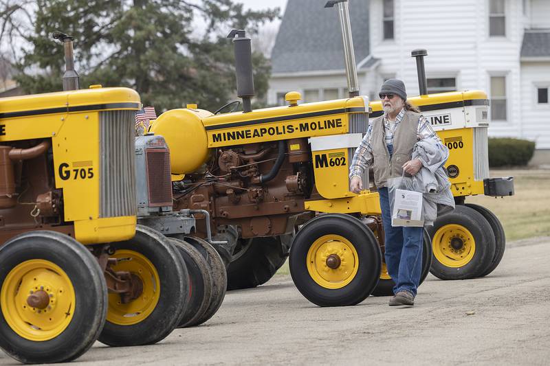 Rick Webster of Toulon looks over a row of Minneapolis-Moline tractors Saturday, March 15, 2025, in Sublette. These tractors along with ones from the Oliver Farm Company were the two featured companies for the outdoor display.