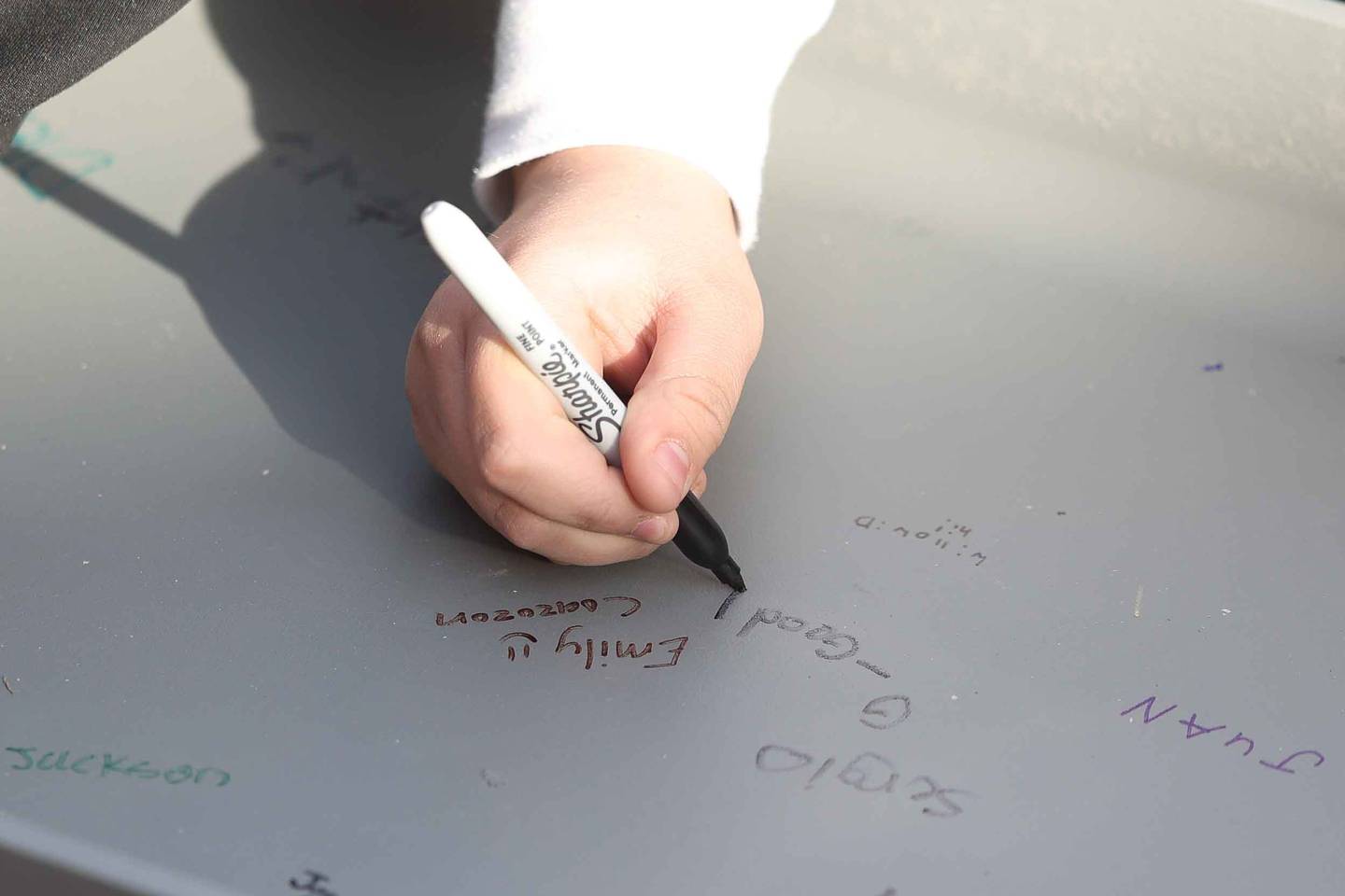 Hufford Junior High School students sign a beam that will be used to build the new school on Friday, Dec. 13, 2024 in Joliet.