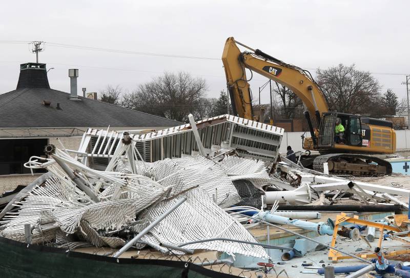 An excavator sifts through debris Tuesday, December 10, 2024, as demolition continues at Hopkins Pool in DeKalb. After the teardown is finished construction will begin on a new pool set to open in 2026.