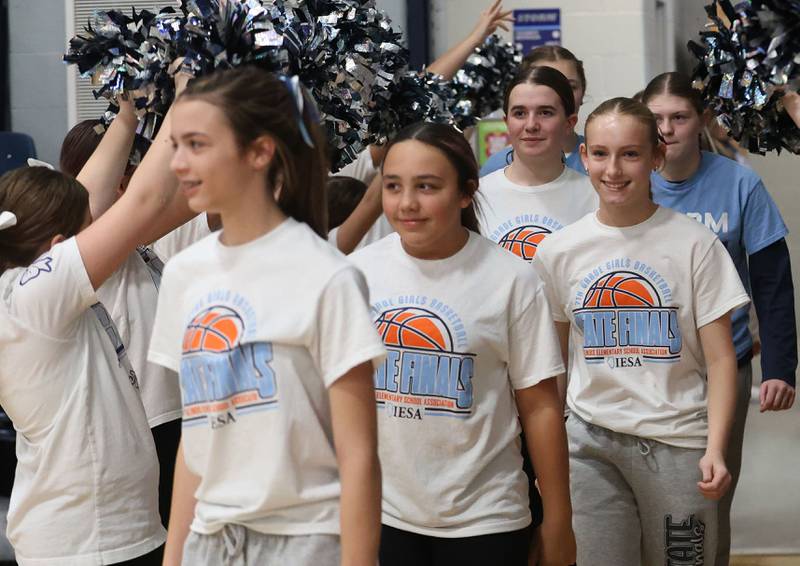 Members of the Bureau Valley Storm seventh-grade girls basketball team enter the gym during a prep rally on Thursday, Dec. 11, 2025 at Bureau Valley High School in Manlius. The Storm (23-1) will meet undefeated Mt. Sterling Brown County (25-0) for the IESA Class 2A state title at 7:30 p.m tonight.