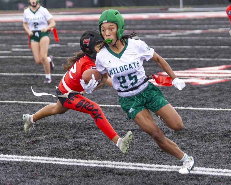 Plainfield Central's Shania Davison (25) takes off down the sidelines with the defense in pursuit during flag football game between Plainfield Central at Bolingbrook Wednesday, Sept 3, 2025  in Bolingbrook.