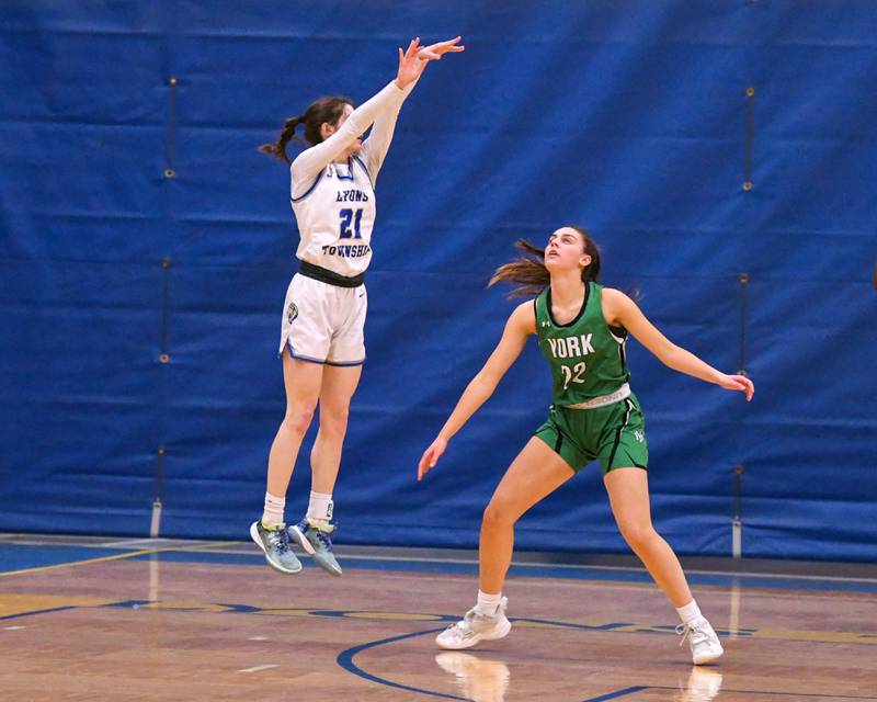 Lyons Township Ally Cesarini (21) takes a shot in the first quarter while being defended by York Stella Kohl (22)  Friday Feb. 3rd at Lyons Township High School.
