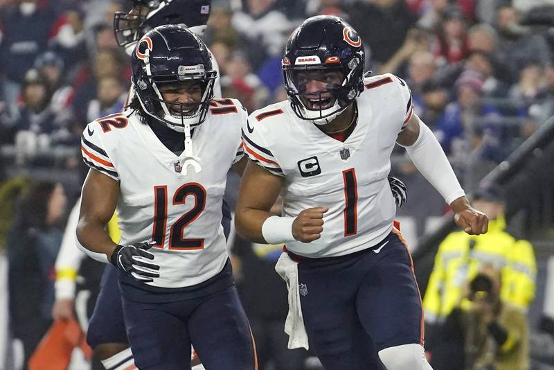 Chicago Bears quarterback Justin Fields, right, celebrates with wide receiver Velus Jones Jr. after his touchdown against the New England Patriots during the first half, Monday, Oct. 24, 2022, in Foxborough, Mass.