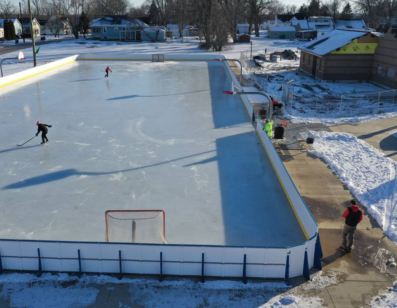 Kids skate and play hockey on the ice rink in Washington Park on Wednesday, Feb. 1, 2023 in Peru.