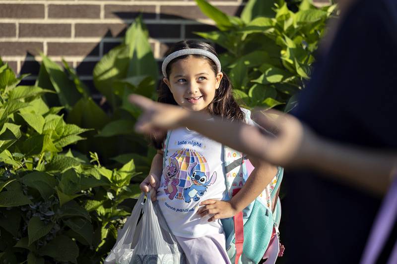 Rem Vetter, 6, poses for pictures Thursday, August 14, 2025, outside of Jefferson School in Sterling after the district welcomes back students for the first day.
