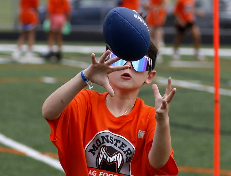 Santino Tarello catches the football during the Chicago Bears Mini Monsters Flag Football Camp on Wednesday, July 16, 2025. at McCracken Field in McHenry.