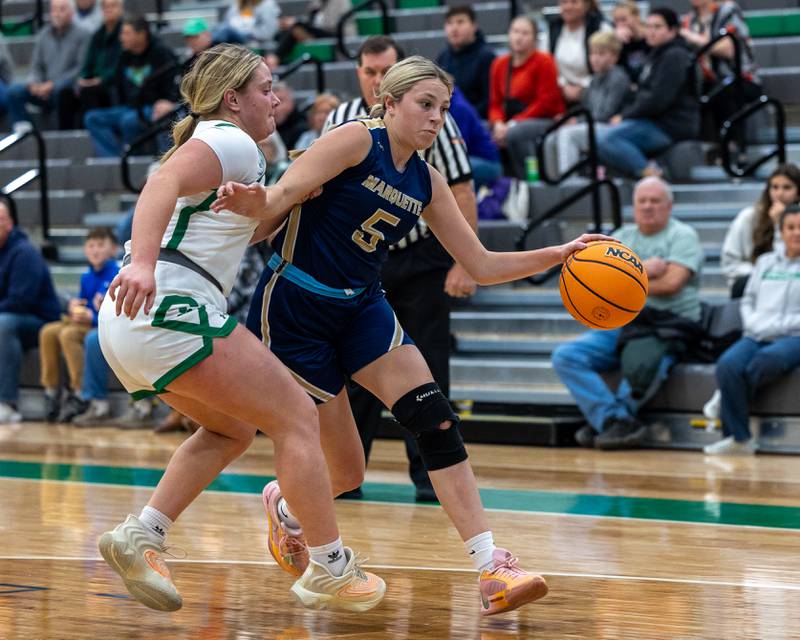 Chloe Thrush (5) of Marquette dribbles ball into lane as Brynlee Hunt (22) of Seneca attempts to defend on Monday, November 17, 2025 at Seneca High School in Seneca.