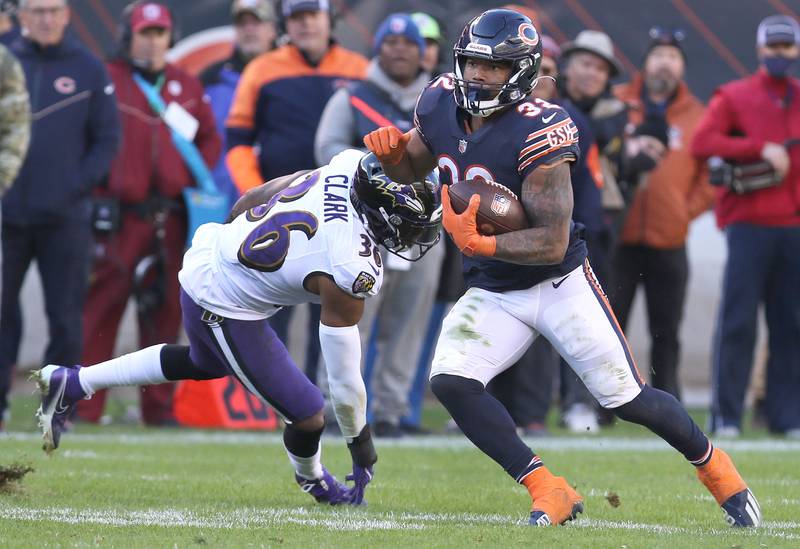 Chicago Bears running back David Montgomery gets by Baltimore Ravens safety Chuck Clark during their game Sunday, Nov. 22, 2021, at Soldier Field in Chicago.