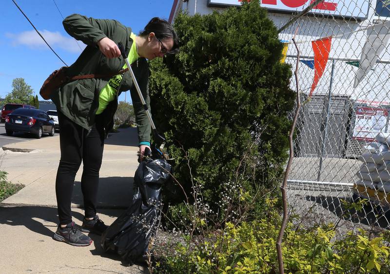 Heather Pursley, of Ottawa, cleans up trash during Operation Clean Sweep on Saturday, April 26, 2025 downtown Ottawa. In honor of Earth Day this week, the Ottawa Downtown Association asked community members to participate in the cleanup. Volunteers helped clean litter throughout downtown Ottawa beginning in the Jordan block.