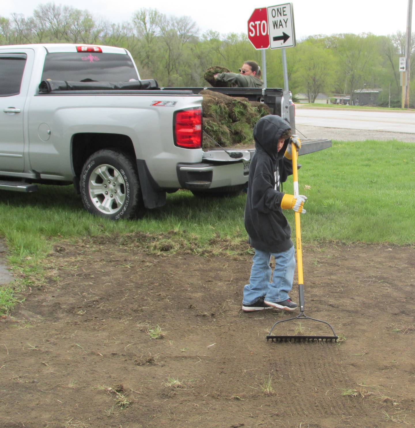 Kamari Johnson helps rake the dirt Saturday, April 22, 2023, at the entrance to Hopalong Cassidy Canoe Launch after it sod was cut from it to make way for a pollinator garden.