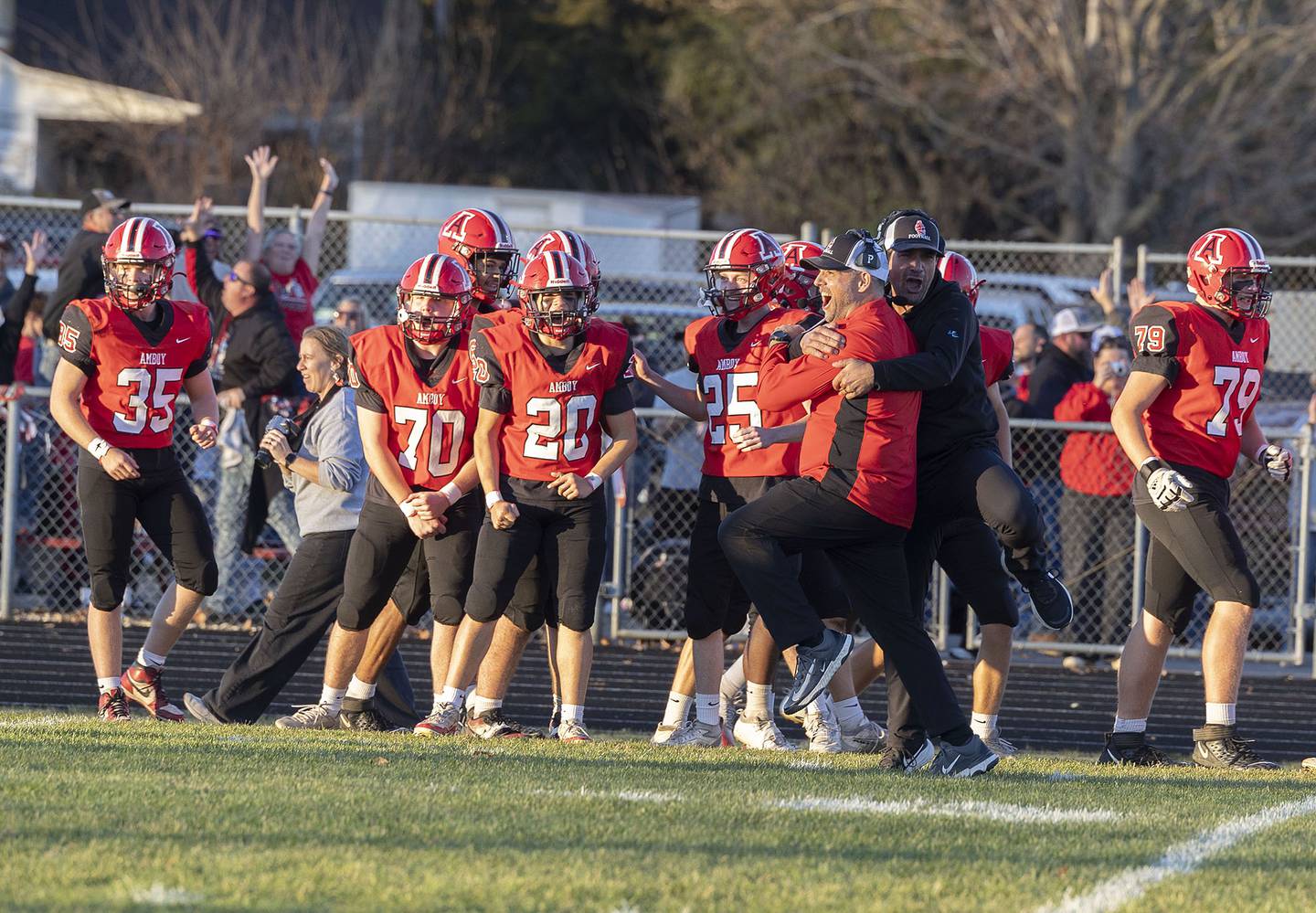 The Amboy sideline celebrates a late game touchdown against Milledgeville Saturday, Nov. 15, 2025, in the 8-man football semifinal.