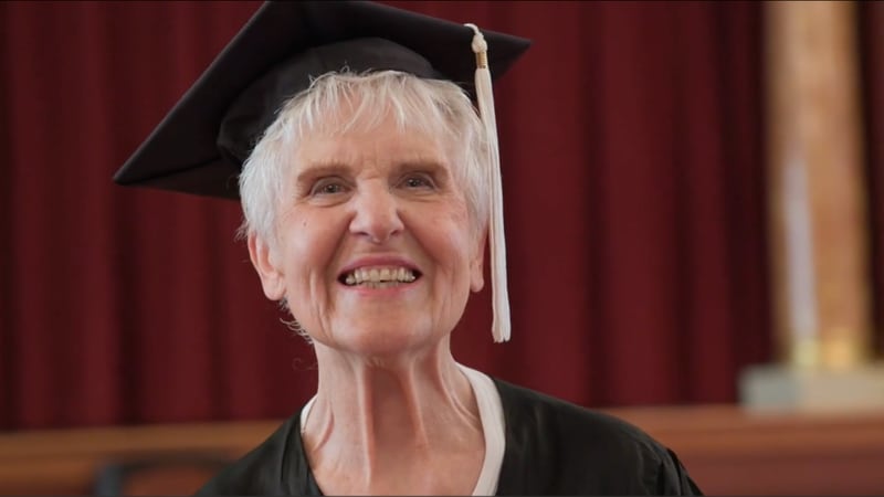 Joyce DeFauw smiles in her graduation hat in the fall of 2022, 71 years after she first attended Northern Illinois University in 1951.