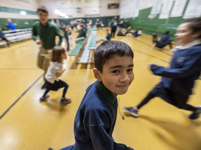 Students run a few laps back and forth in the gym at St. Andrew Catholic School in Rock Falls on Thursday, Feb. 2, 2023.