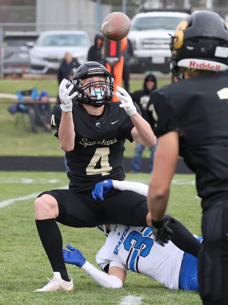 Sycamore's Aidan Wyzard juggles the ball after a hit from St. Francis' Seth Valeri Saturday, Nov. 16, 2024, during their Class 5A quarterfinal game at Sycamore High School.