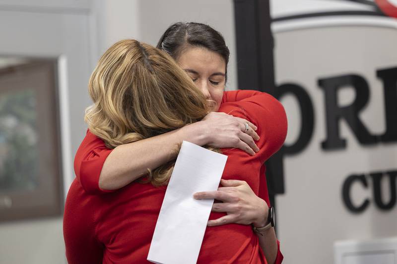 Oregon High School Principal Heidi Deininger, left, hugs National Teacher of the Year finalist Kimberly Radostits on Wednesday, Jan. 25, 2023.