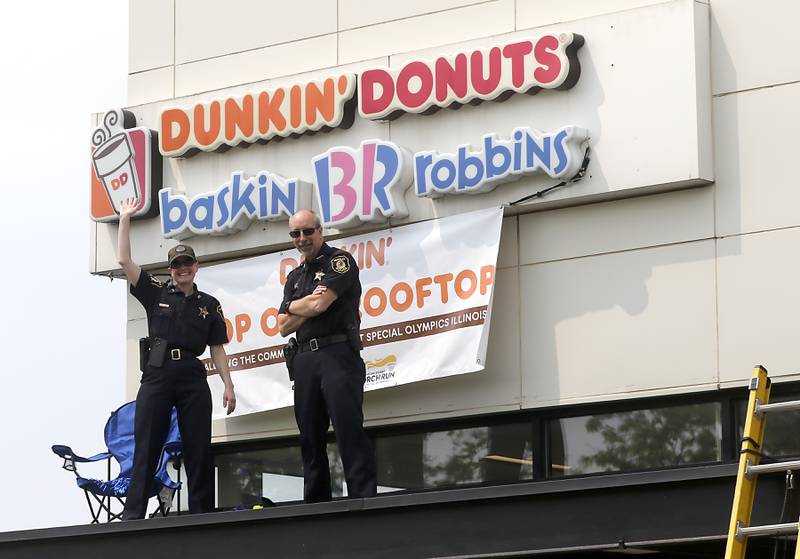 Huntley Police Department Deputy Chief Amy Willams and Police Chief Robert Porter on the roof of the Dunkin’ at 12090 Princeton Drive in Huntley, during the Cop on a Rooftop fundraiser on Friday, May 19, 2023. Huntley Police Department officers, in support of the Law Enforcement Torch Run for Special Olympics Illinois, took to the roofs and ground around both Huntley Dunkin’ locations before finishing the day with the seventh annual doughnut-eating contest that was won by Matthew Ganek of the Huntley Police Department.