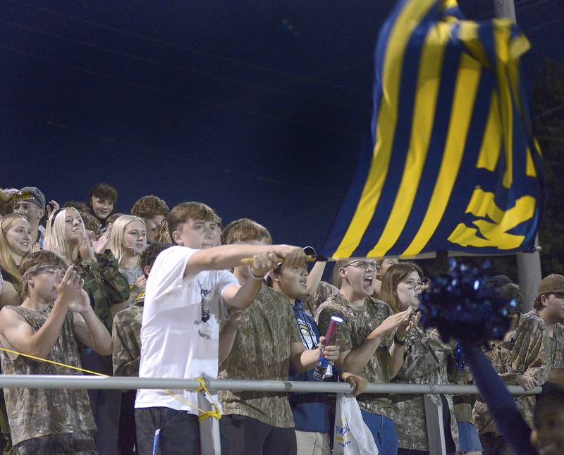 Marquette Crusader fans wave their flag after the Crusaders score against Seneca Friday at Marquette.