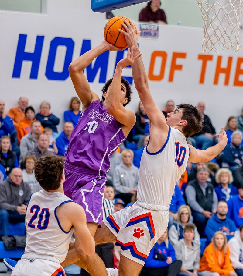 Pecatonica's Zion Braimah is blocked by Eastland's Zyacan Haverland during the first half of play on Thursday, Dec. 19, 2024.