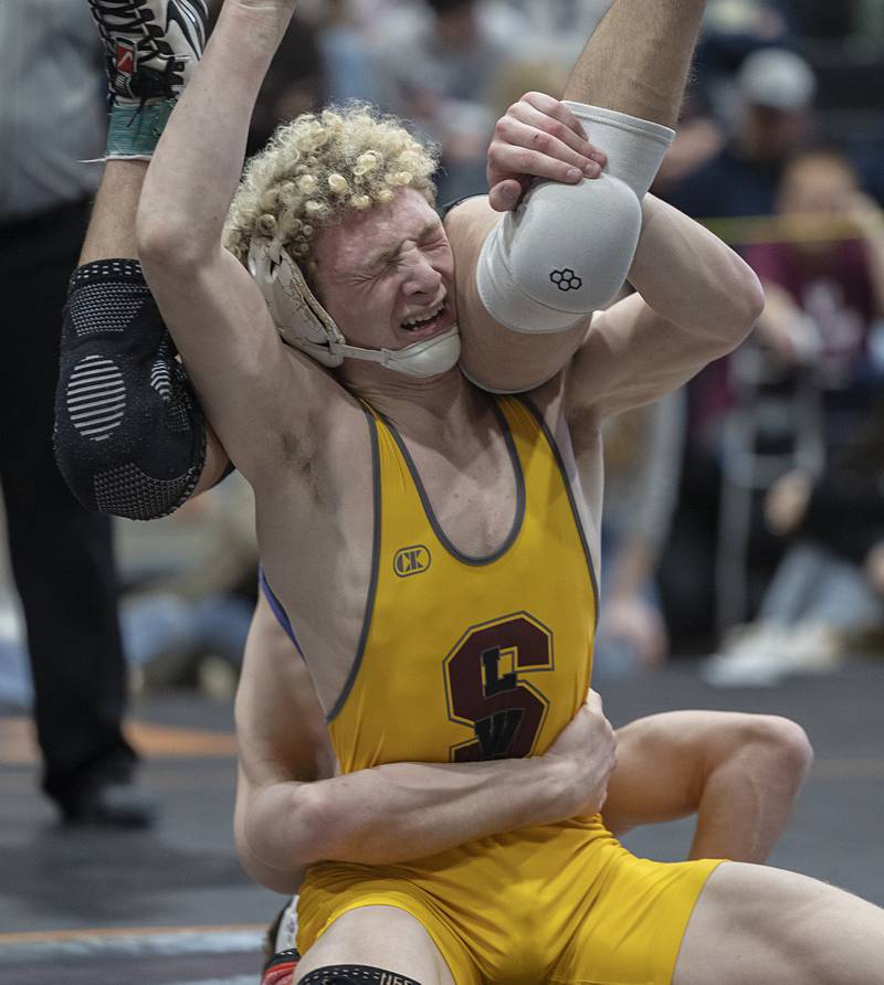 Arrison Bauer grimaces against Dixon’s Charlie Connors in the 144 pound first place match Saturday, Feb. 14, 2026, during the Class 1A wrestling sectionals in Byron.