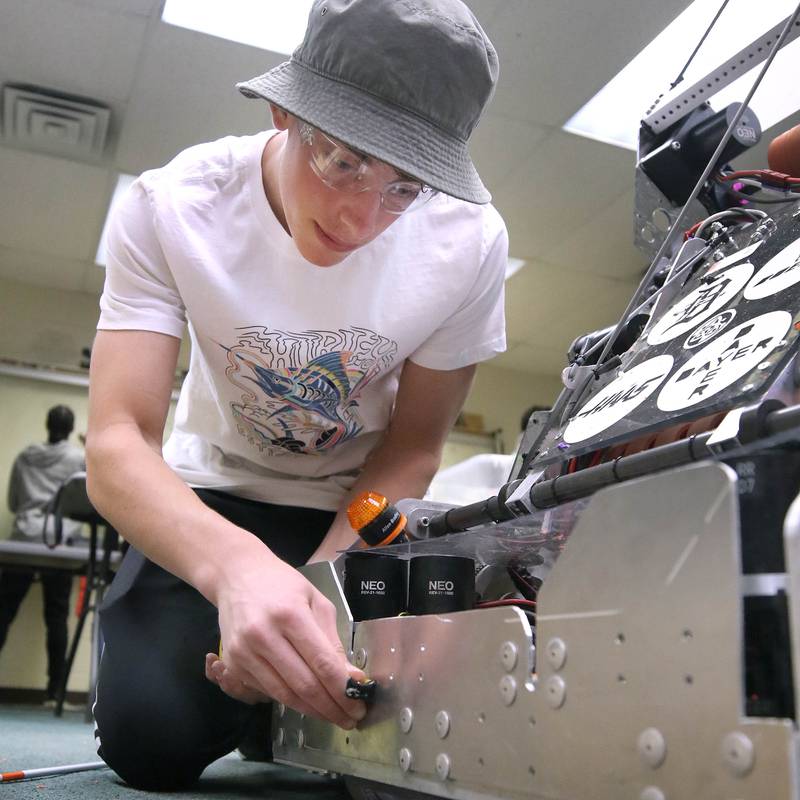 Nathan Tumminaro, a junior at DeKalb High School, takes some measurements on his team’s robot during a Crowbotics team meeting Tuesday, April 10, 2024, at Huntley Middle School in DeKalb. Crowbotics is DeKalb High School’s robotics team who has qualified to compete in the FIRST Robotics Competition World Championship held in Houston, Texas April 17-20.