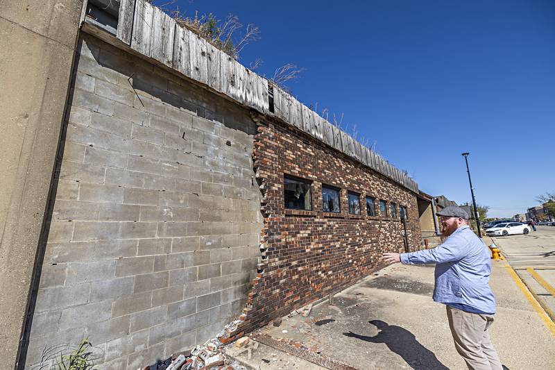 Facade bricks peeling off the exterior do create a hazard for walkers on the sidewalk.