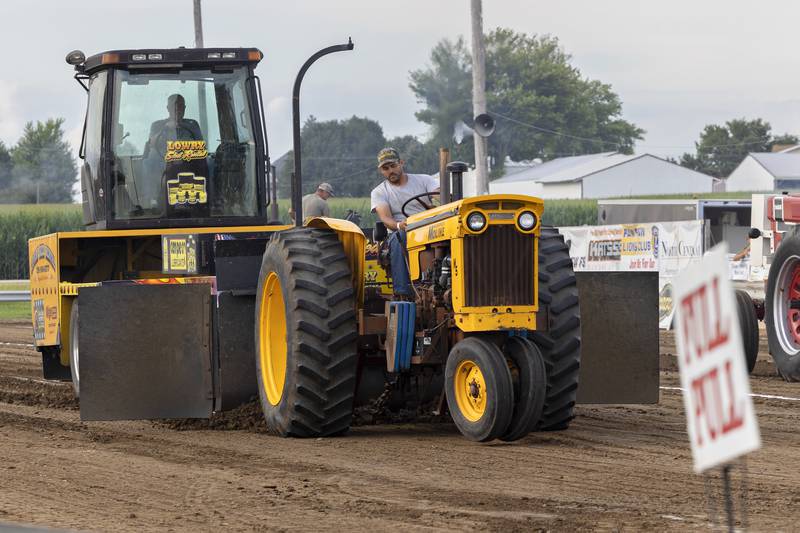 Adam Betz maneuvers his tractor as the sled bites into the track Thursday, July 24, 2025, at the Lee County Fair.