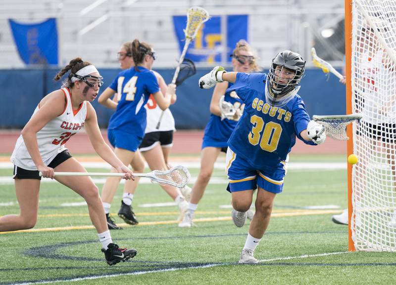 Crystal Lake Central Co-Op's Olivia Castro battles for a loose ball with Lake Forest goal keeper Juju Hunt during the girls lacrosse supersectional match on Tuesday, May 31, 2022 at Hoffman Estates High School.