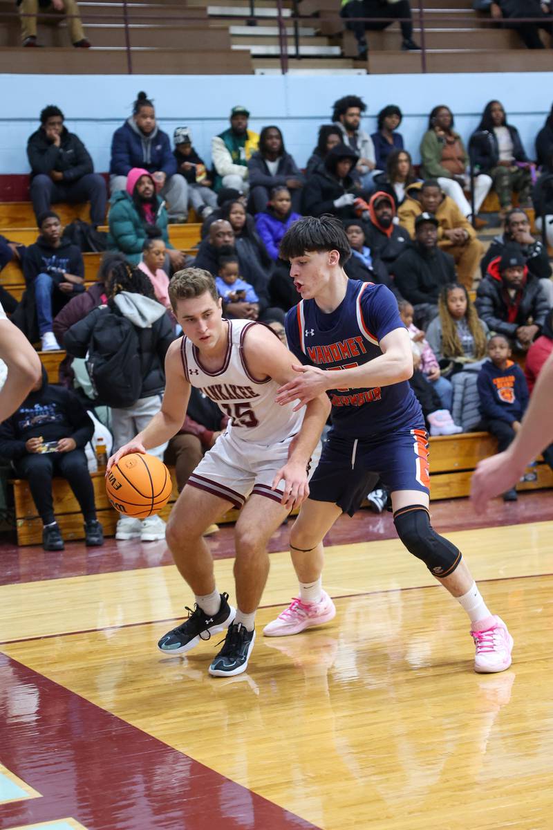 Kankakee's Eli Cunningham tips a rebound to teammate during the Kays' 74-60 victory over Mahomet-Seymour on Tuesday, Dec. 2, 2025.