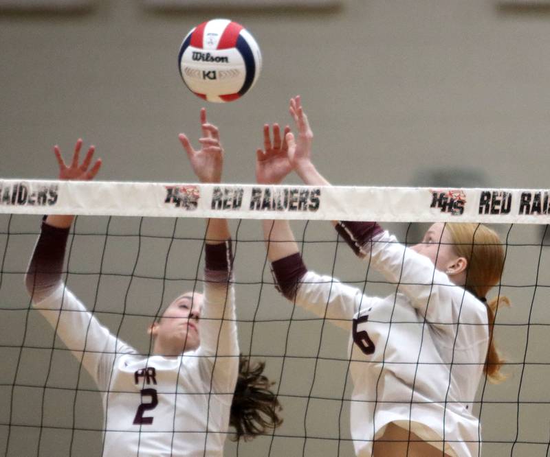Prairie Ridge’s Addi Smith, left, and Sonora Bekere block in varsity girls volleyball at Huntley High School in Huntley on Thursday, Sept. 11, 2025.