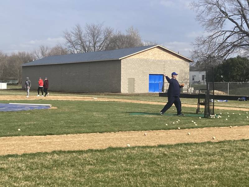 Assistant coach Brock Hanson throws batting practice at Prather Field, which has now added a new hitting facility along the right field foul line. When completed, the facility will be used by the PHS baseball and softball teams along with the Logan Junior High softball team.