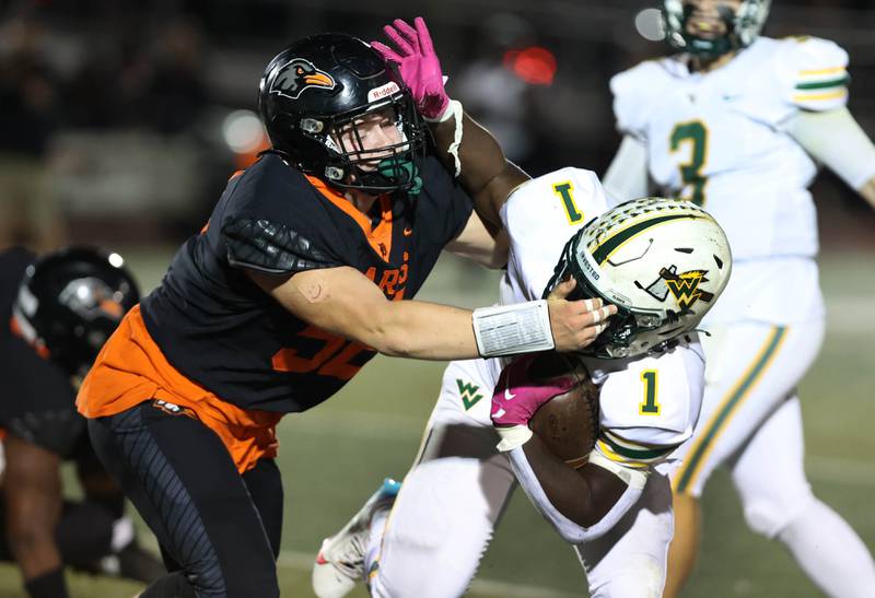 DeKalb’s Owen Sisson brings down Waubonsie Valley's Chrisjan Simmons during their game Friday, Sept. 29, 2023, at DeKalb High School.