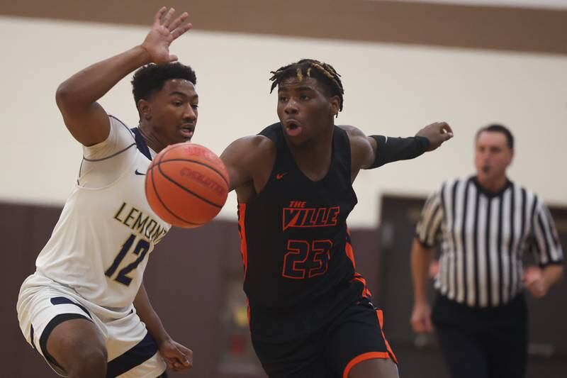 Romeoville’s Denonte Cunningham drives around Lemont’s Miles Beachum in the WJOL Thanksgiving Classic Championship in Joliet on Saturday.